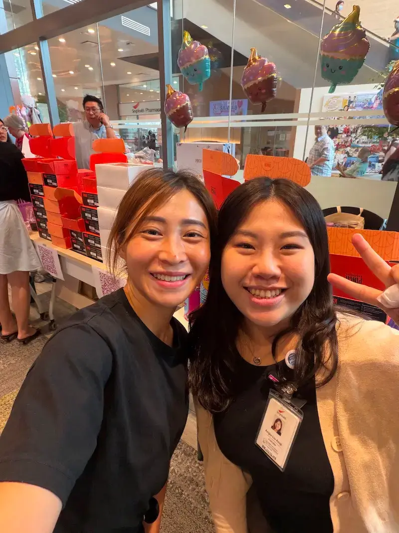 Pinch Bakehouse team member with NCCS staff member during the successful charity bake sale in Singapore
