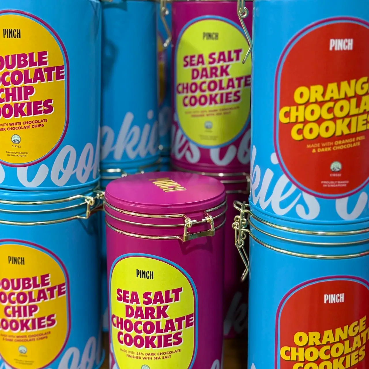 Pinch Bakehouse halal cookie tins in Orange Chocolate, Sea Salt Dark Chocolate and Double Chocolate Chip flavours