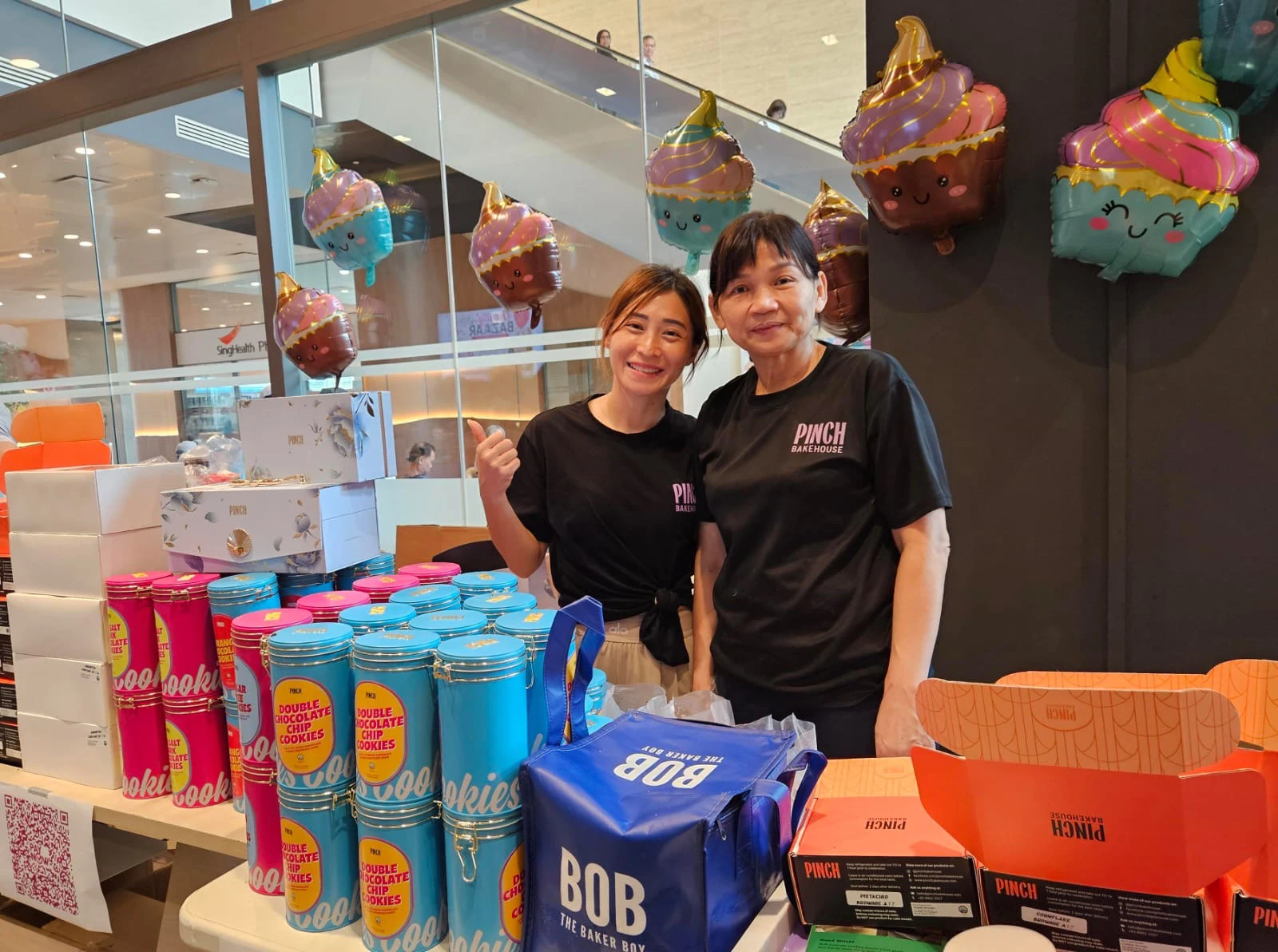 Pinch Bakehouse team handing over a corporate gift box at a pop-up